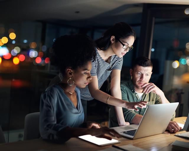 A small team working together at a laptop